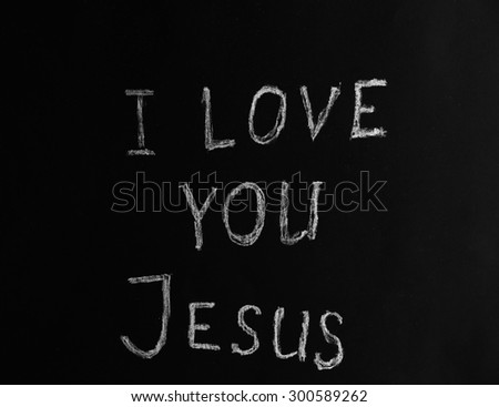 I LOVE YOU JESUS illustrated with chalk on black paper background