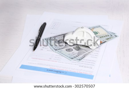 Toy car, money and documents on table. Car insurance concept