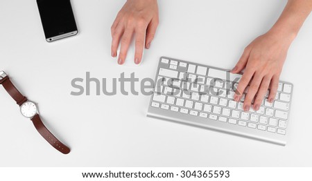 Female hand with computer keyboard isolated on white