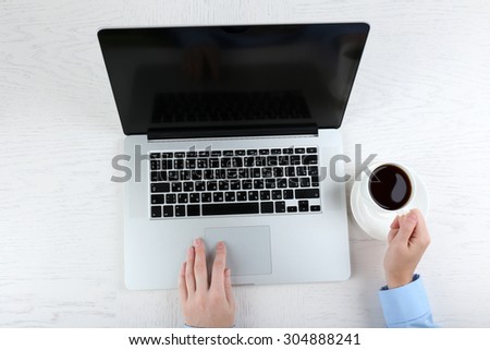 Hands working in the office with laptop on white table