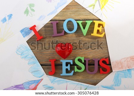I LOVE JESUS sign illustrated with colorful plastic letters on drawings background