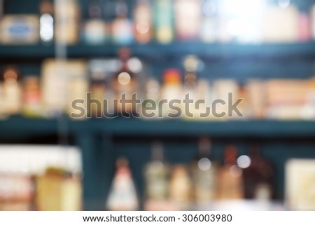 Blurred chemicals and laboratory utensils on shelves