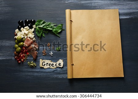 Map of Greece made with ingredients of traditional Greek cuisine on color wooden background
