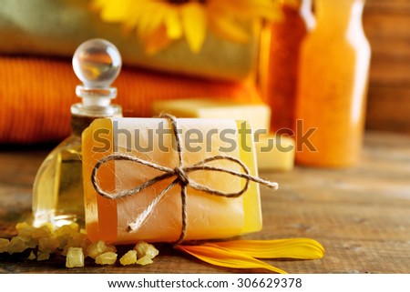 Massage oil and spa treatments, sunflower on wooden background