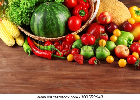 Composition with fresh fruits and vegetables on wooden background
