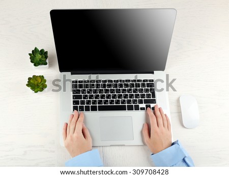 Hands working in the office with laptop on white table