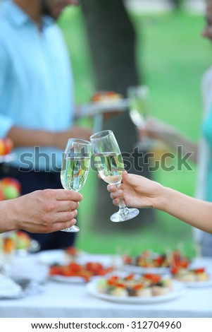 Guests drink champagne on wedding ceremony