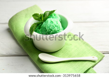Homemade mint ice-cream on light wooden background