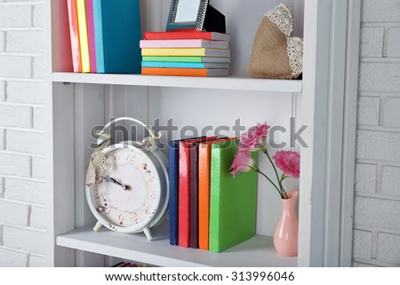 Books and decor on shelves in cupboard