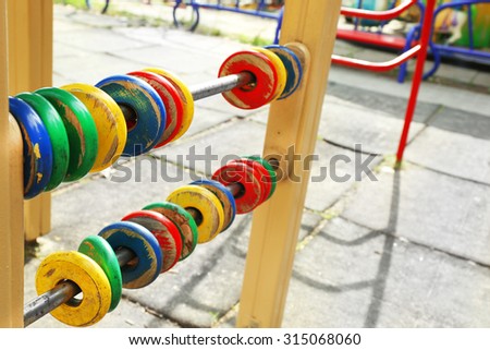 Colorful wooden rings for count on playground