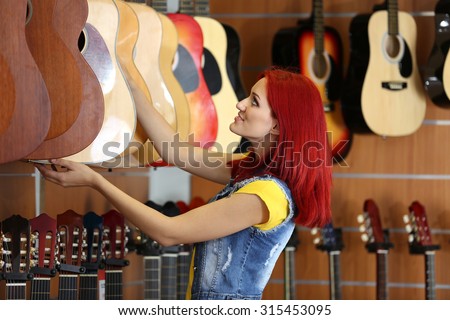 Beautiful young woman in music store