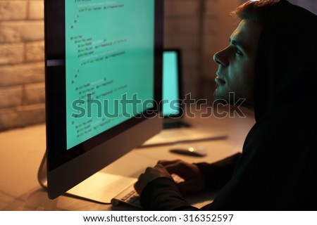 Hacker with computer and laptop