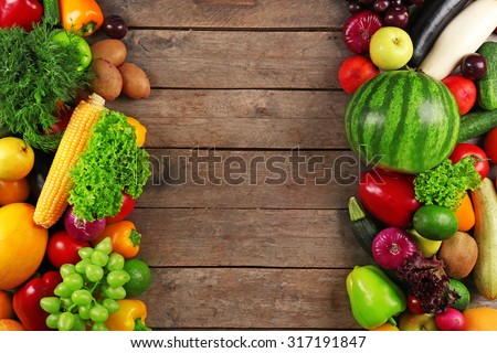 Frame of fresh vegetables on wooden background
