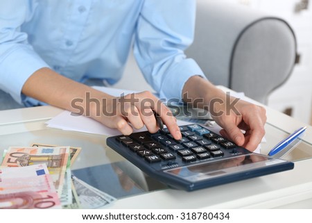 Accounting concept.Analyzing finance report with calculator