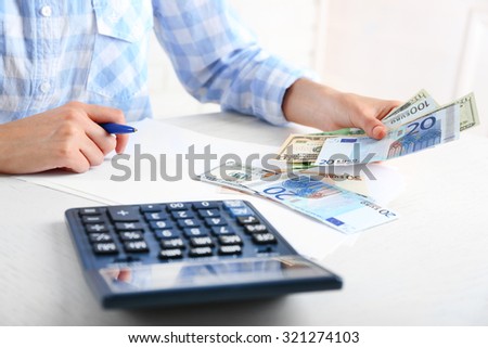 Accounting concept.Analyzing finance report with calculator