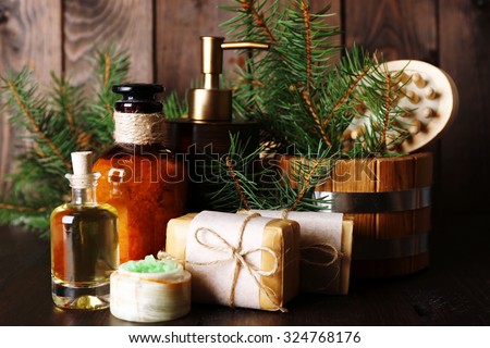 Essential oil of pine, handmade soap and cream with pine extract and spa treatments on wooden background