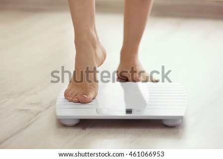 Female leg stepping on floor scales Stock foto © 