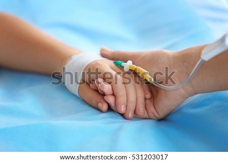 Child hand with catheter on bed Foto stock © 