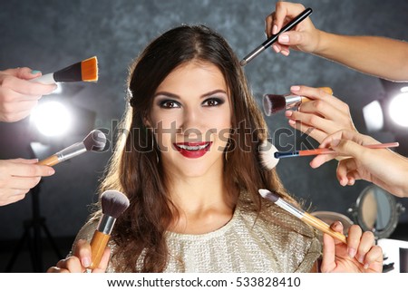 Similar – Image, Stock Photo Professional visagiste applying powder on model face