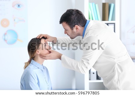 Similar – Image, Stock Photo Male doctor examining patient in medical room