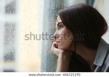 Depressed young woman near window at home, closeup Foto d'archivio © 