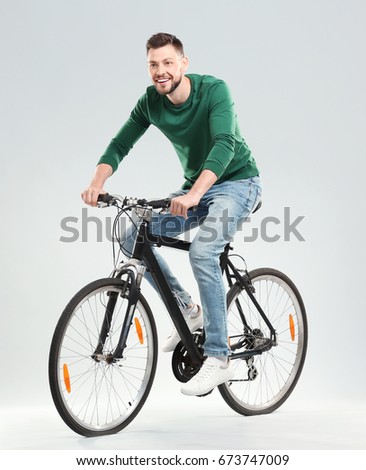 Similar – Image, Stock Photo Young man riding bicycle