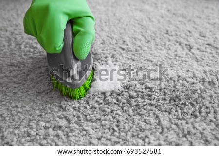 Hand in rubber glove cleaning carpet with brush, close up ストックフォト © 