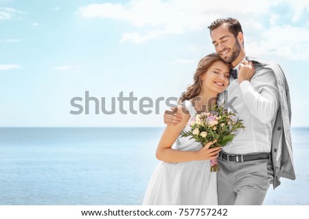 Similar – Image, Stock Photo Happy newlywed couple standing against waving sea