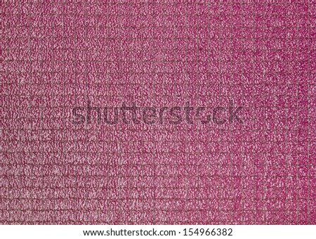 Metallic net in glass and magenta background behind it