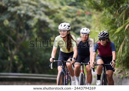 Similar – Image, Stock Photo Group of cyclist friends riding race bike on sunset highway, sunset bike competition.