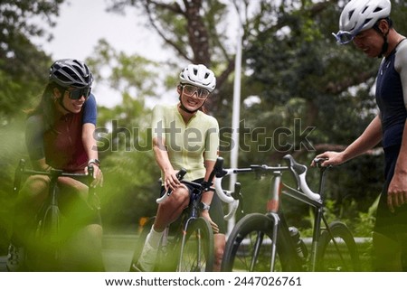 Similar – Image, Stock Photo Group of cyclist friends riding race bike on sunset highway, sunset bike competition.