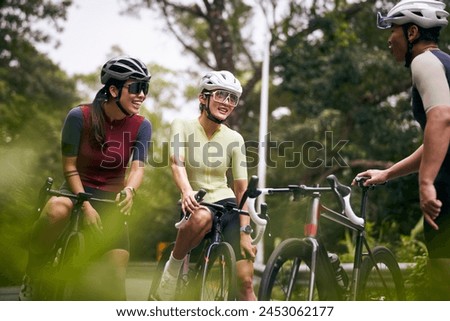 Similar – Image, Stock Photo Group of cyclist friends riding race bike on sunset highway, sunset bike competition.