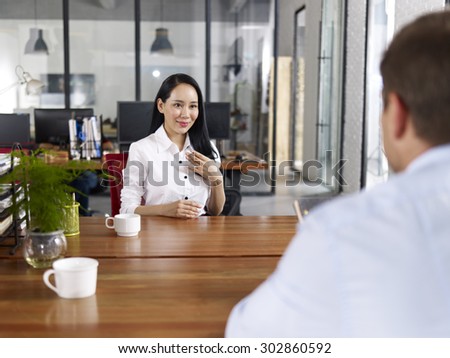 young asian businesswoman looking confident making a self introduction during a job interview.
