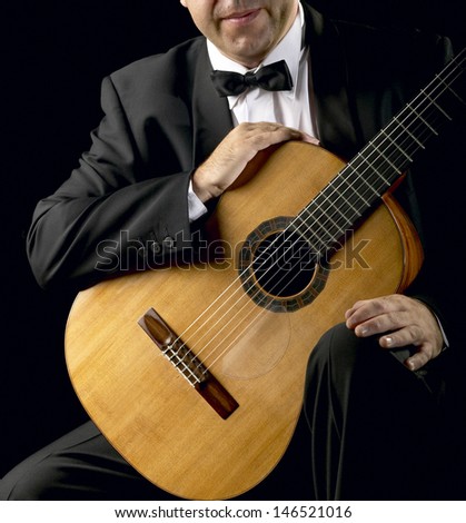 Classical Guitarist with Smoking Jacket low key image square format Unrecognizable person