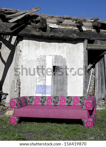New Sofa in an abandoned rural place vertical