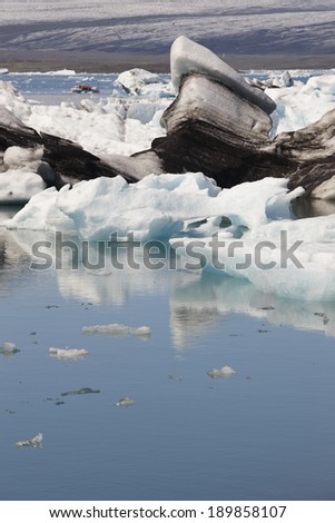 Icelandic landscape with icebergs, lake and glacier. Vertical