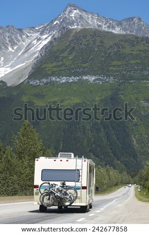 Canadian highway with motorhome and cars. British Columbia. Canada. Vertical