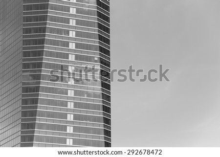 Modern metallic and glass building facade in black and white. Horizontal