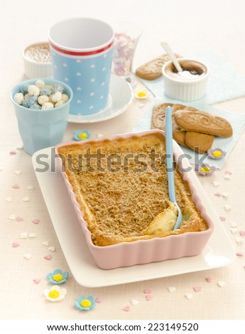 children flan with cookies decorated with sweet flowers spekulis chocolates on bright background