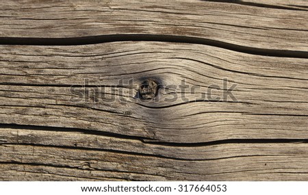 Old shaky wood plank with knot texture photo