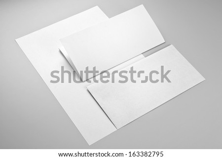 Envelope and two sheets of paper, one of them folded