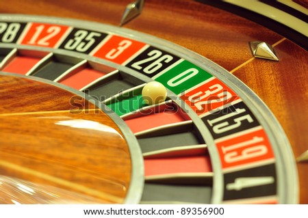image with a casino roulette wheel with the ball on number 0