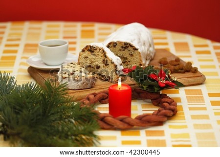 Christmas cake and advent wreath with candle and cup of coffee