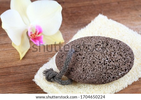 Volcanic pumice stone on the  washcloth  in rustic style. Pumice stone with a string on the wooden table, decorated with beautiful orchid.   ストックフォト © 