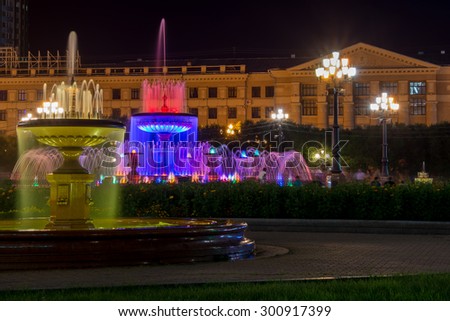 Illuminated fountains on the main square of Khabarovsk, Russia - Lenin Square at night