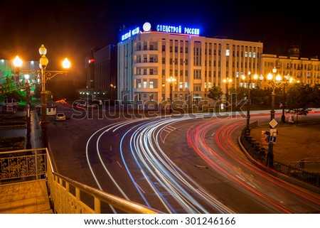 KHABAROVSK - JUL 26: The moving stream of cars at night along the main street of Khabarovsk (inscription on the house: Special construction Russia) on July 26, 2015 in Khabarovsk, Russia