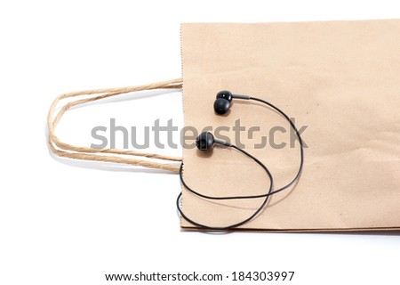 Brown paper bag lunch with earphone isolated on white background. Green technology concept.
