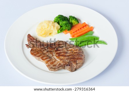 Grilled Pork Steak with Boiled Vegetables Isolated on a White Background