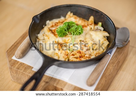 Cheesy baked macaroni and cheese pasta portion with parmesan sprinkled on top - soft focus point