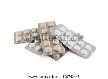 Pile of blister bubble pack pills isolated over white background